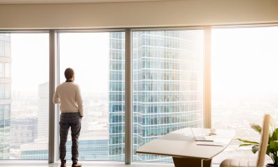 ceo looks out of skyscraper window
