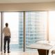 ceo looks out of skyscraper window