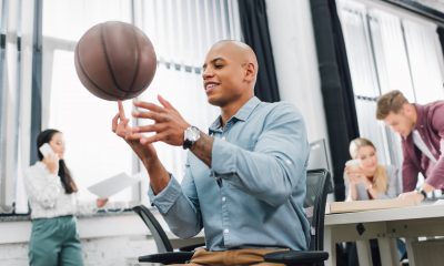 office worker playing basketball at work