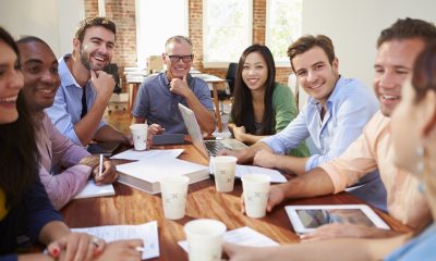 office workers happy in a meeting with coffee